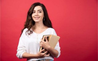 brunette-woman-with-books-standing-red-background-high-quality-photo
