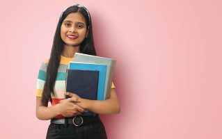 smiling-young-indian-asian-girl-student-posing-islolated-holding-folders-looking-directly-camera-dark-haired-female-expressing-positive-emotions-mock-up-copy-space